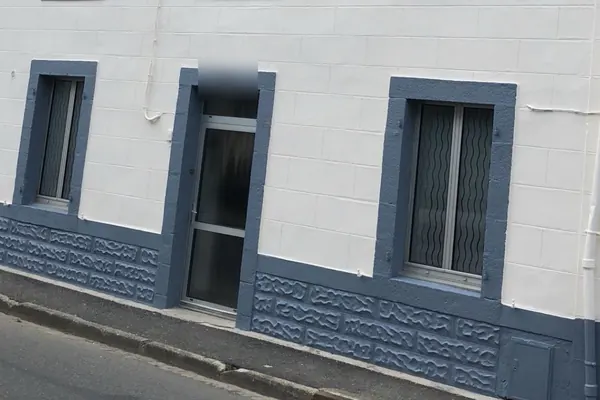 Encadrements de fenêtres et soubassement repeints en gris bleu sur une façade blanche